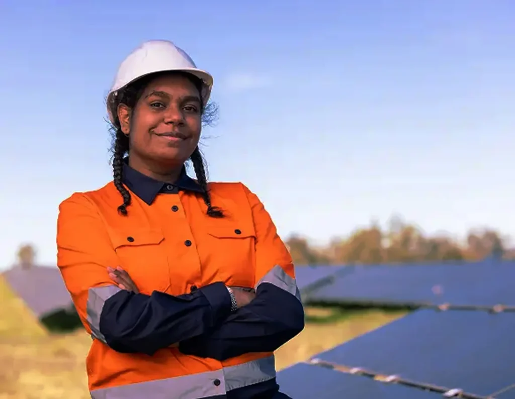 Worker in high-visibility workwear standing at a solar site