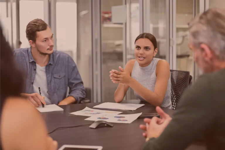 Team members discussing a project around a table